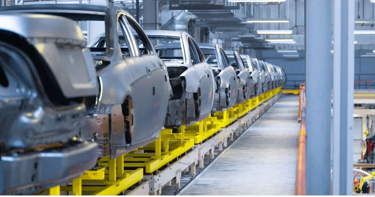 Multiple incomplete car frames on an assemble line in a factory